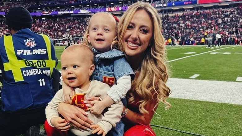 Brittany Mahomes and her two kids at the edge of the Super Bowl field