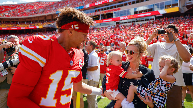 Patrick Mahomes, Bronze Mahomes, Brittany Mahomes, and Sterking Mahomes on a football field