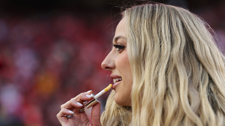 Brittany Mahomes applying lip gloss
