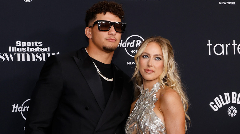 Brittany and Patrick Mahomes posing for photos