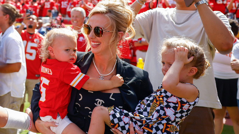 Brittany Mahomes laughing while she holds her kids
