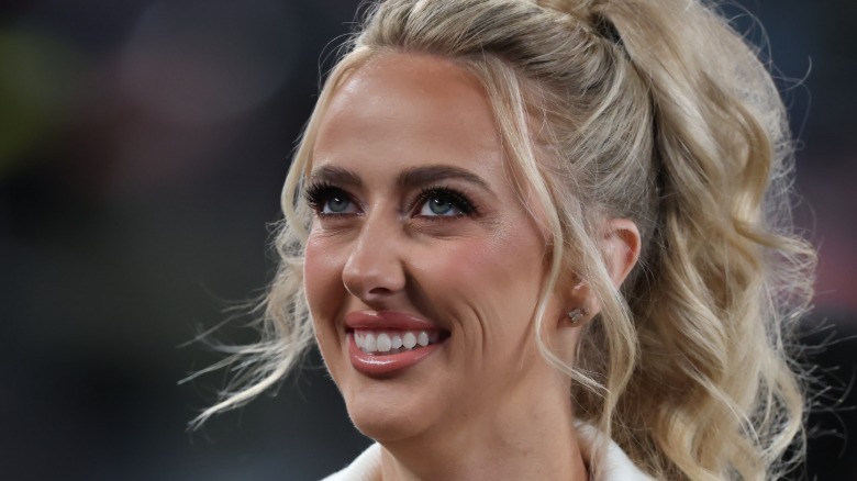 Brittany Mahomes smiling with her hair up in a ponytail