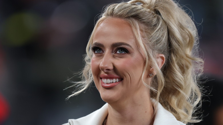 Brittany Mahomes smiling with her hair up in a ponytail