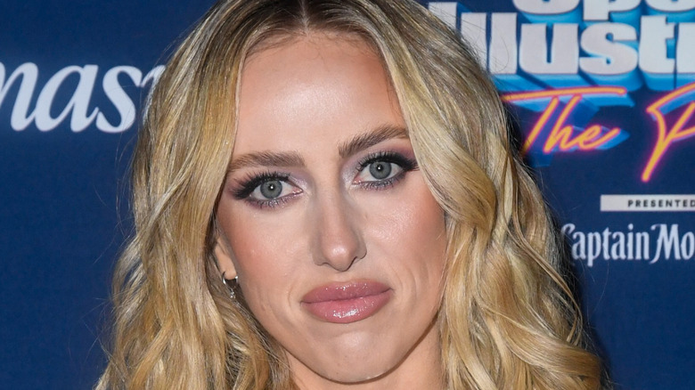 Brittany Mahomes posing at an event with wide eyes