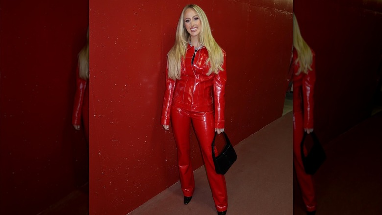 Brittany Mahomes poses in a red leather jacket and pants