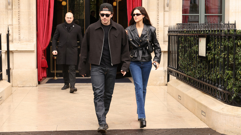 Brooklyn Beckham and Nicola Peltz walking together in 2024