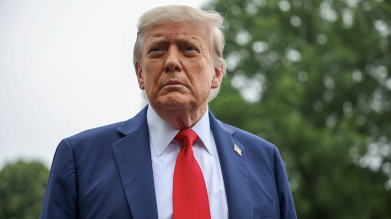 Donald Trump looking displeased in his signature red tie