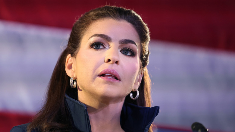 A closeup of Casey DeSantis wearing silver hoops and a high collar