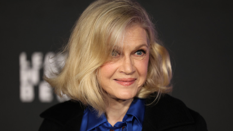 Diane Sawyer posing for photos in a blue blouse