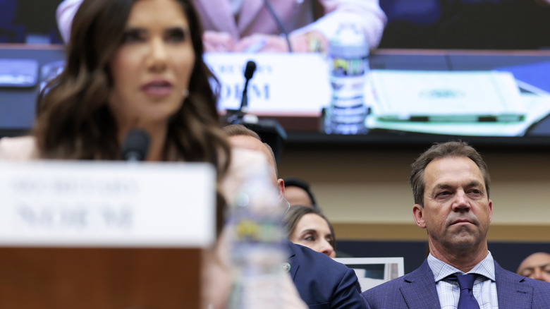 Bryon Noem sitting behind Kristi Noem at Senate hearing