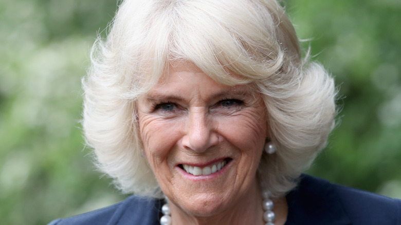 Camilla Parker Bowles in pearls and dark dress