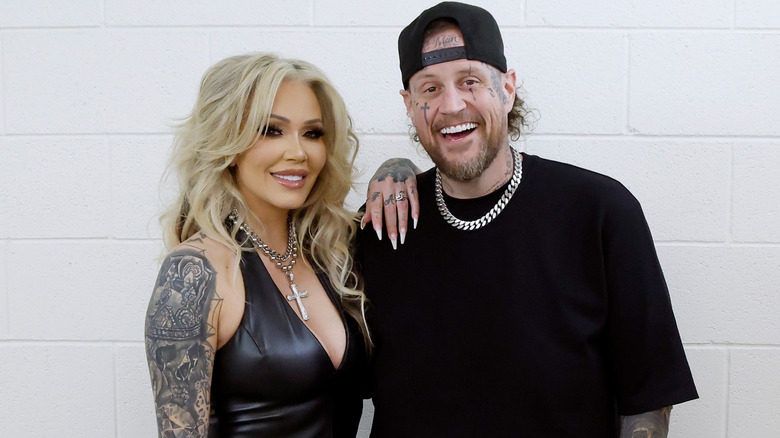 Bunnie Xo and Jelly Roll smile together in matching black