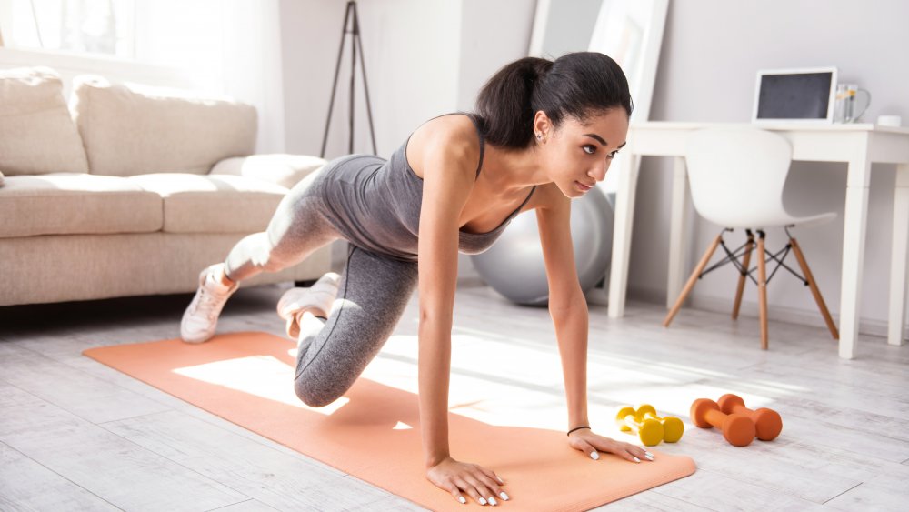 woman working out at home calisthenics weight training