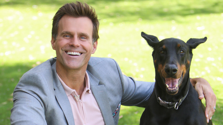 Cameron Mathison beside his family dog Red
