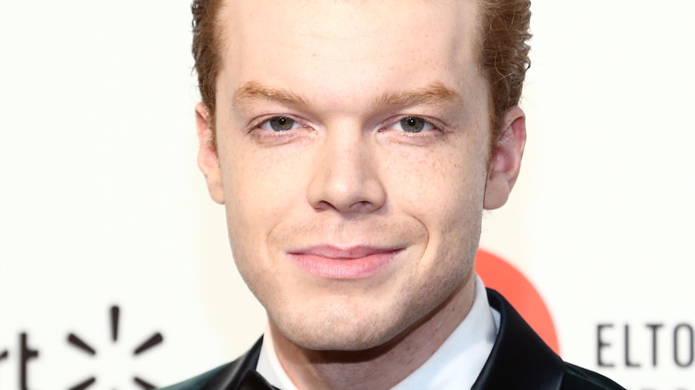 Cameron Monaghan smiling at event   