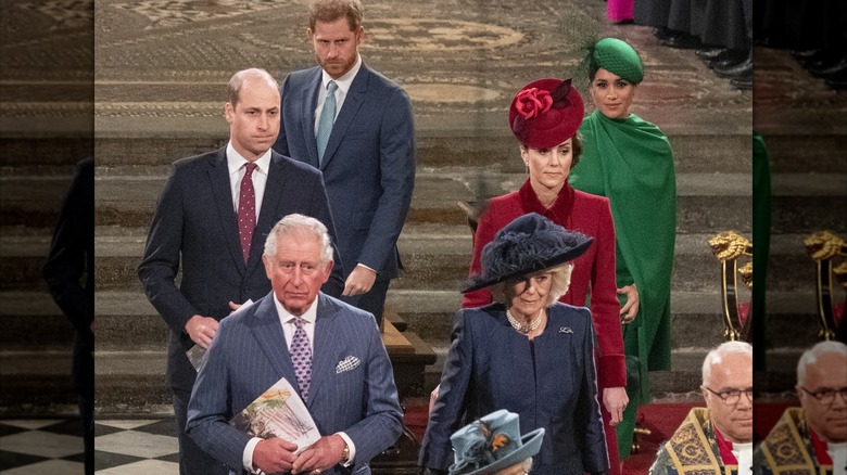 King Charles III and Queen Camilla standing in front of Prince William and Prince Harry