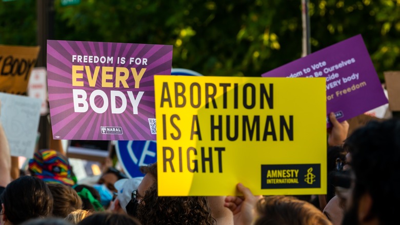 pro-abortion protestors holding signs and marching