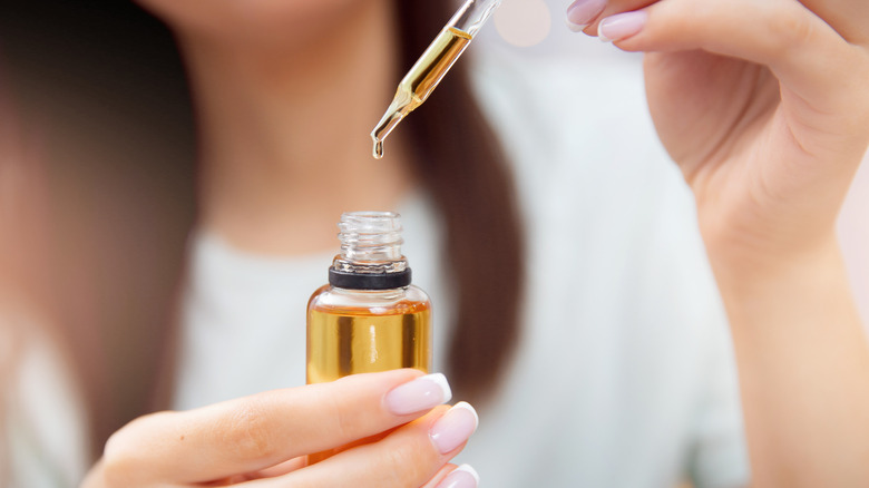 Woman holding castor oil