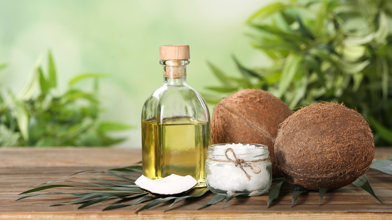 Coconuts on a table with coconut oil