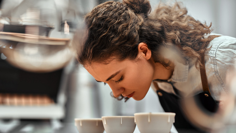 Woman smelling coffee