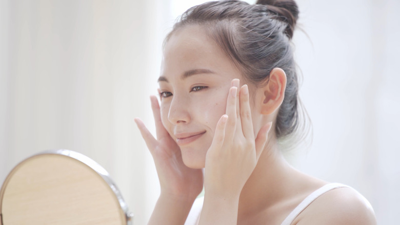 Woman smiling at the mirror