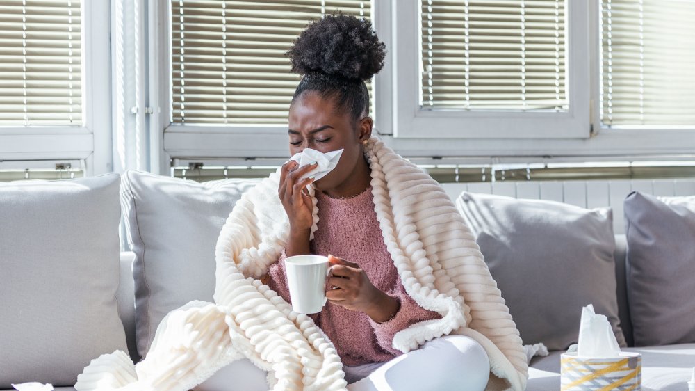 woman with cold and tissues