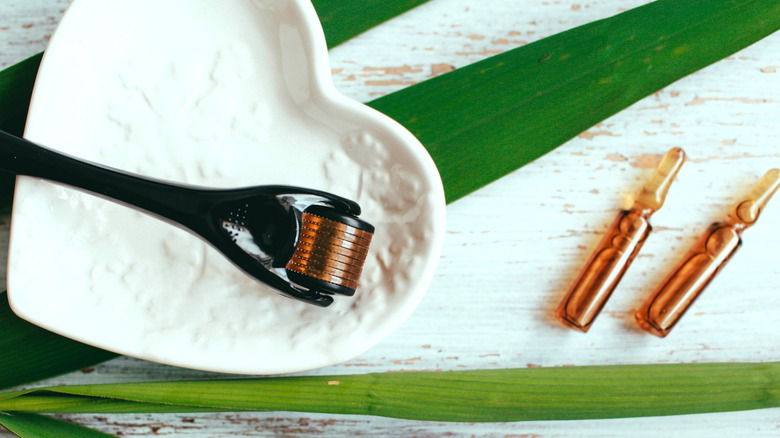 Dermaroller next to a facial serum 