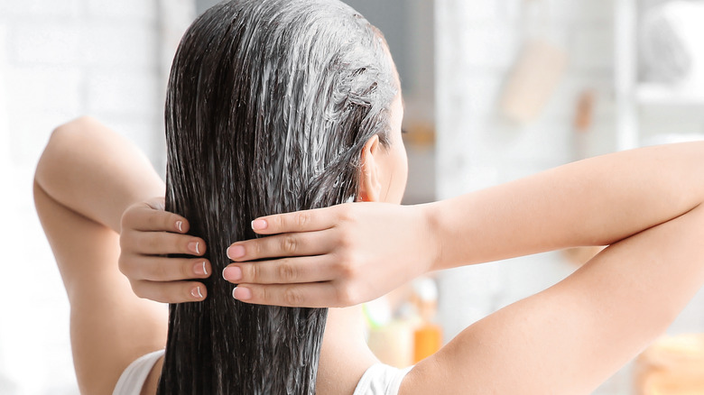 woman applying conditioner