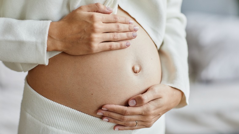 Pregnant woman holding her belly