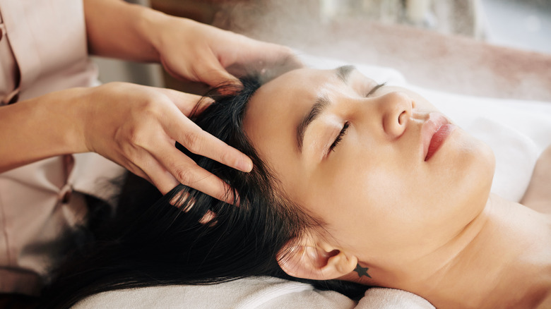 Woman getting scalp massage