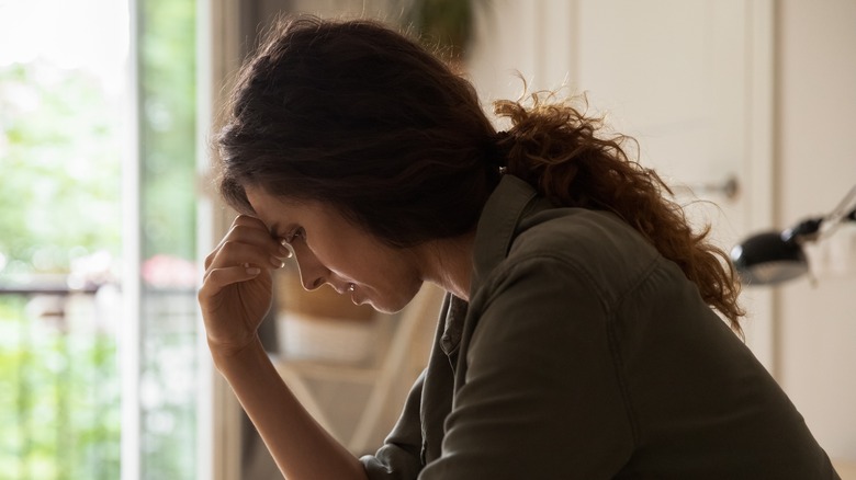 Woman worried with hand to head