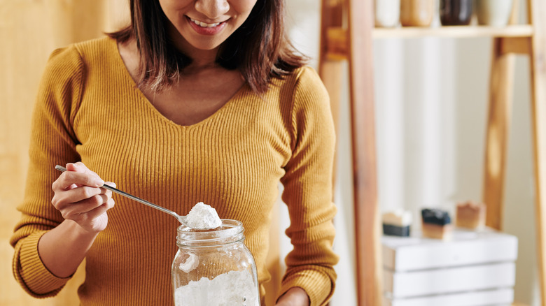 woman holding jar of baking soda