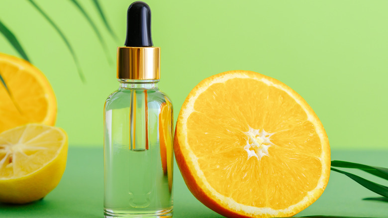 Vitamin C serum next to an orange 