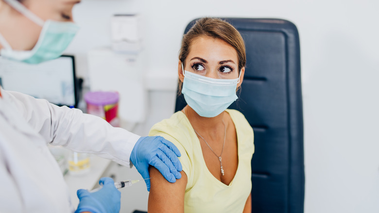 Woman getting a shot in the arm