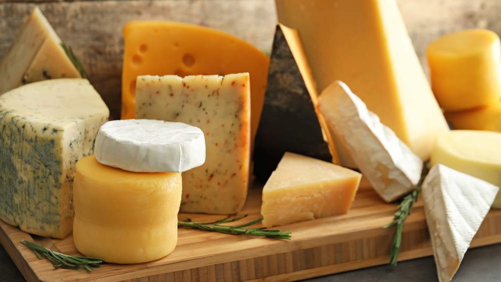 Cheeses displayed on a board 