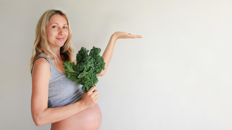 Pregnant Woman Holding Kale