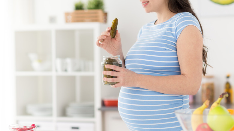 Pregnant woman with pickle jar