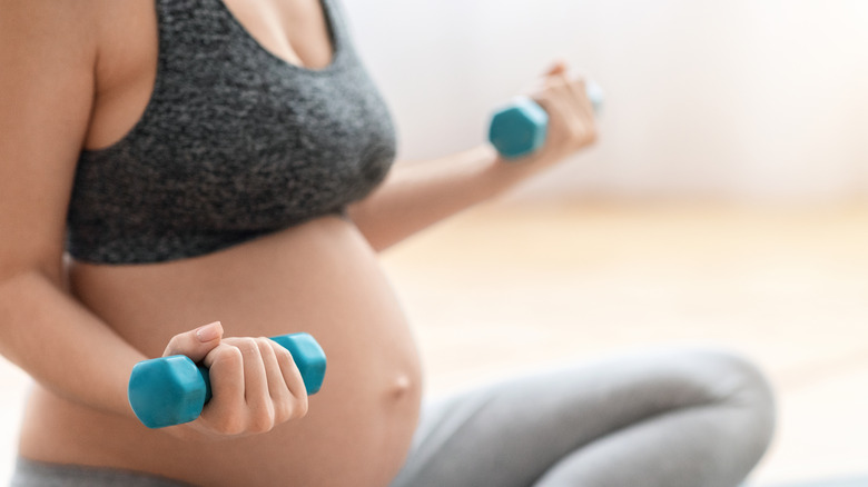 Pregnant person lifting light weights