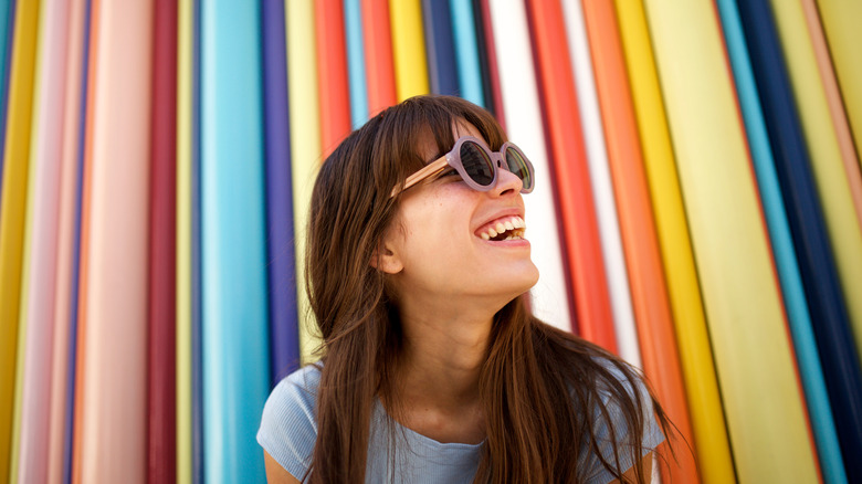Woman laughing with colorful background