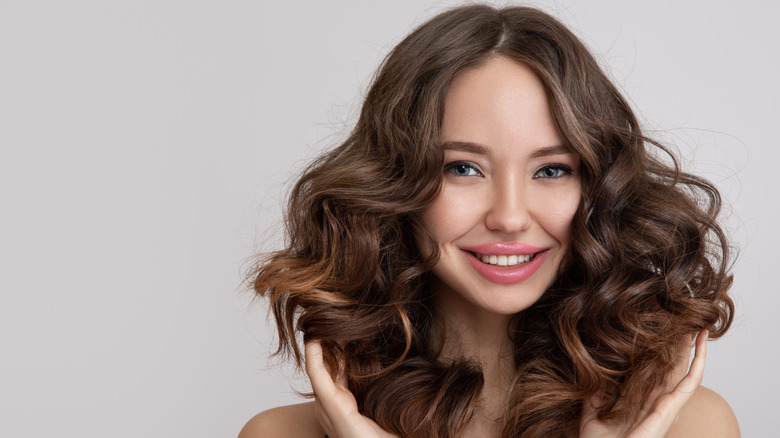 Smiling woman with permed hair