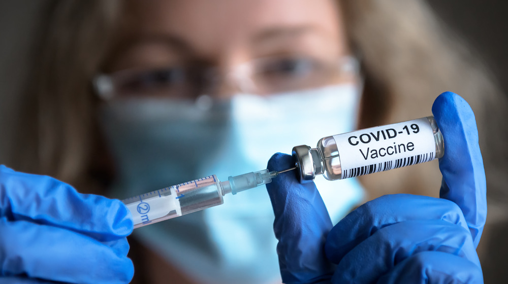 Doctor holding COVID-19 vaccination