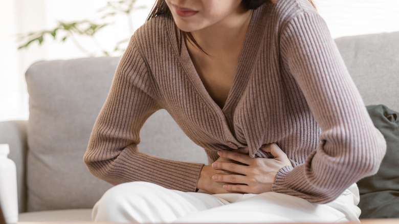 Woman holding abdomen