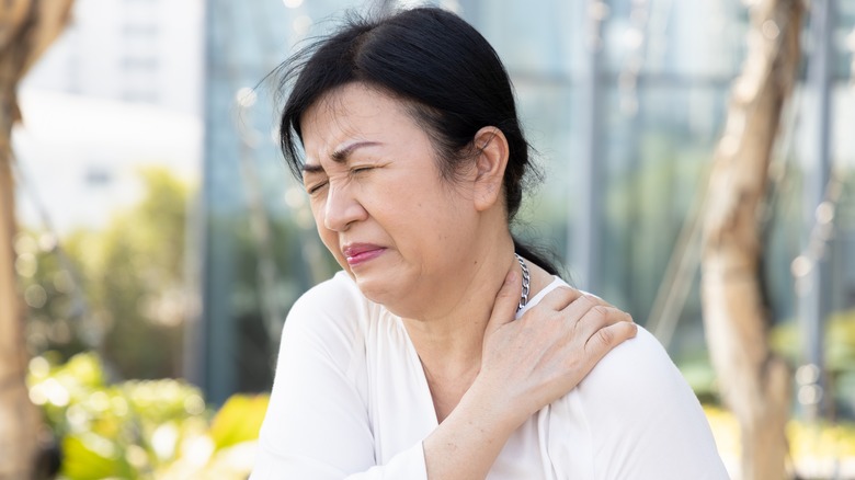 Woman with shoulder pain and stiffness due to osteoporosis