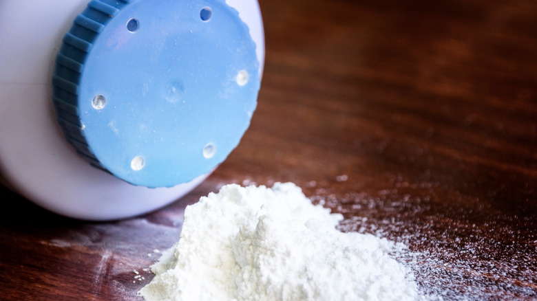 Baby powder spilling onto a wooden surface