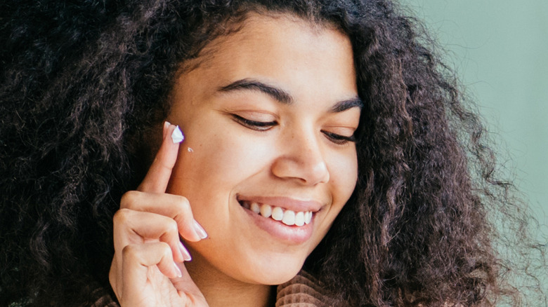 Applying lotion to the face