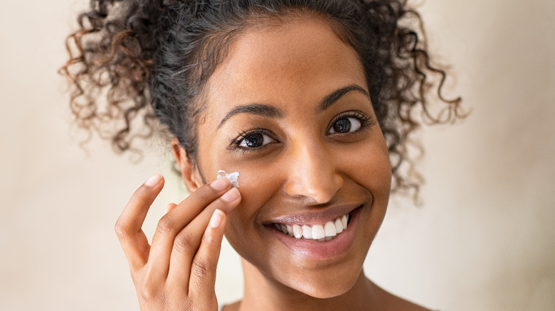 Putting lotion on the face