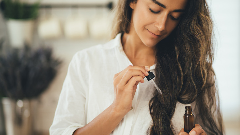 woman applying hair oil