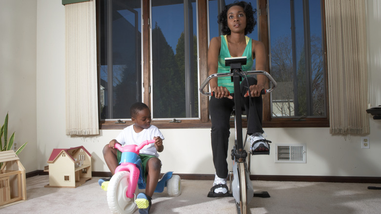 mom and son riding stationary bikes