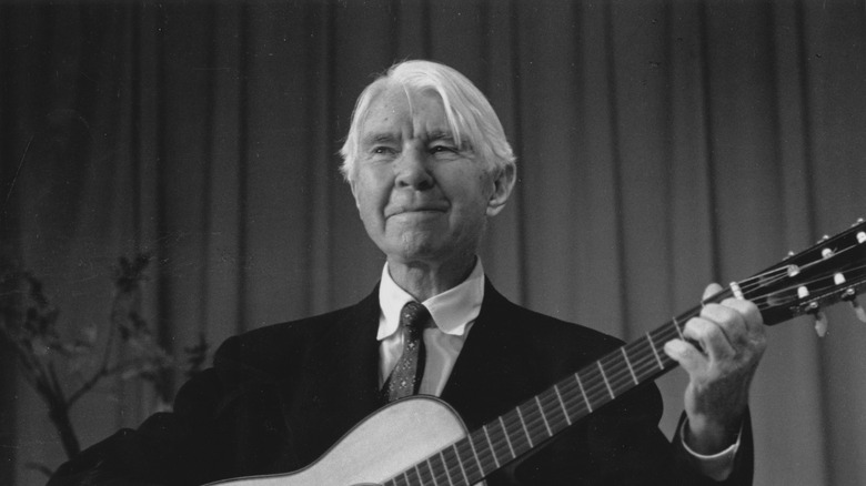 Carl Sandburg playing the guitar