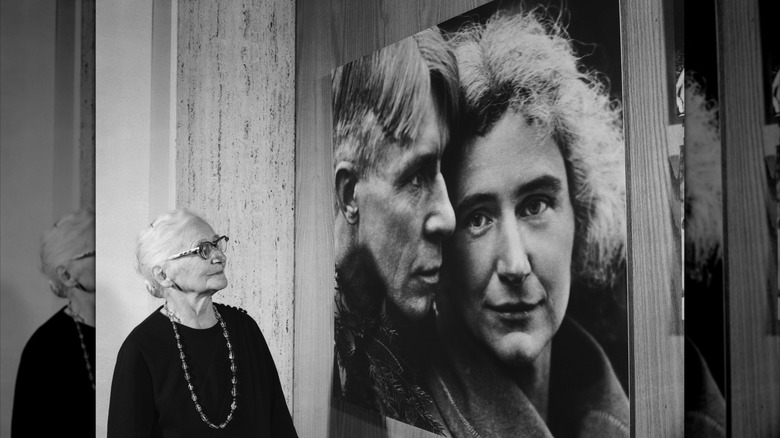 Lilian "Paula" Steichen looking at a photo of herself and her late husband Carl Sandburg